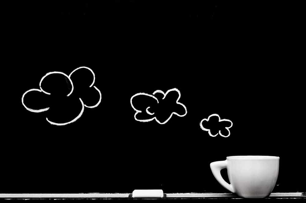 coffee cup with chalk board cloud drawing