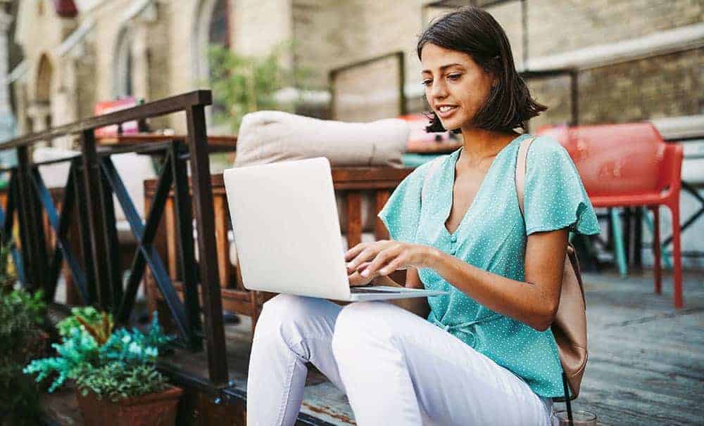 woman writing blog on laptop