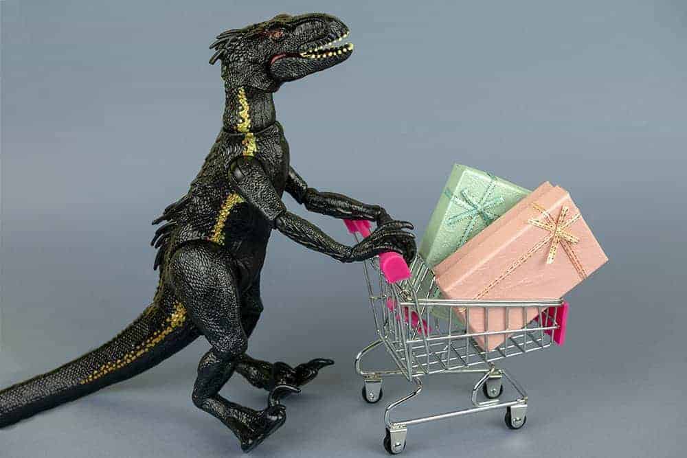 toy dinosaur pushing shopping cart